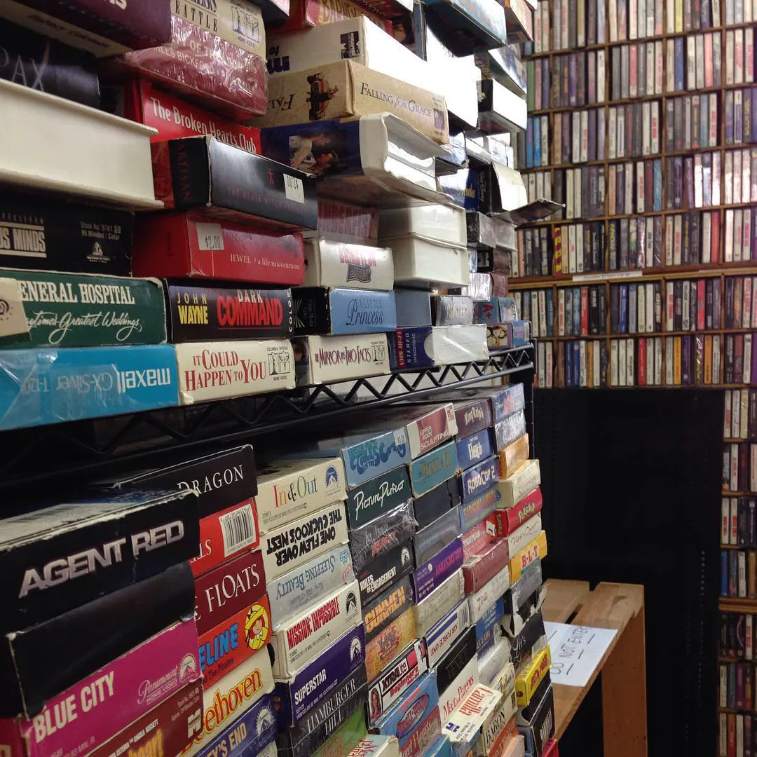 Shelves crammed with old VHS tapes and cassettes