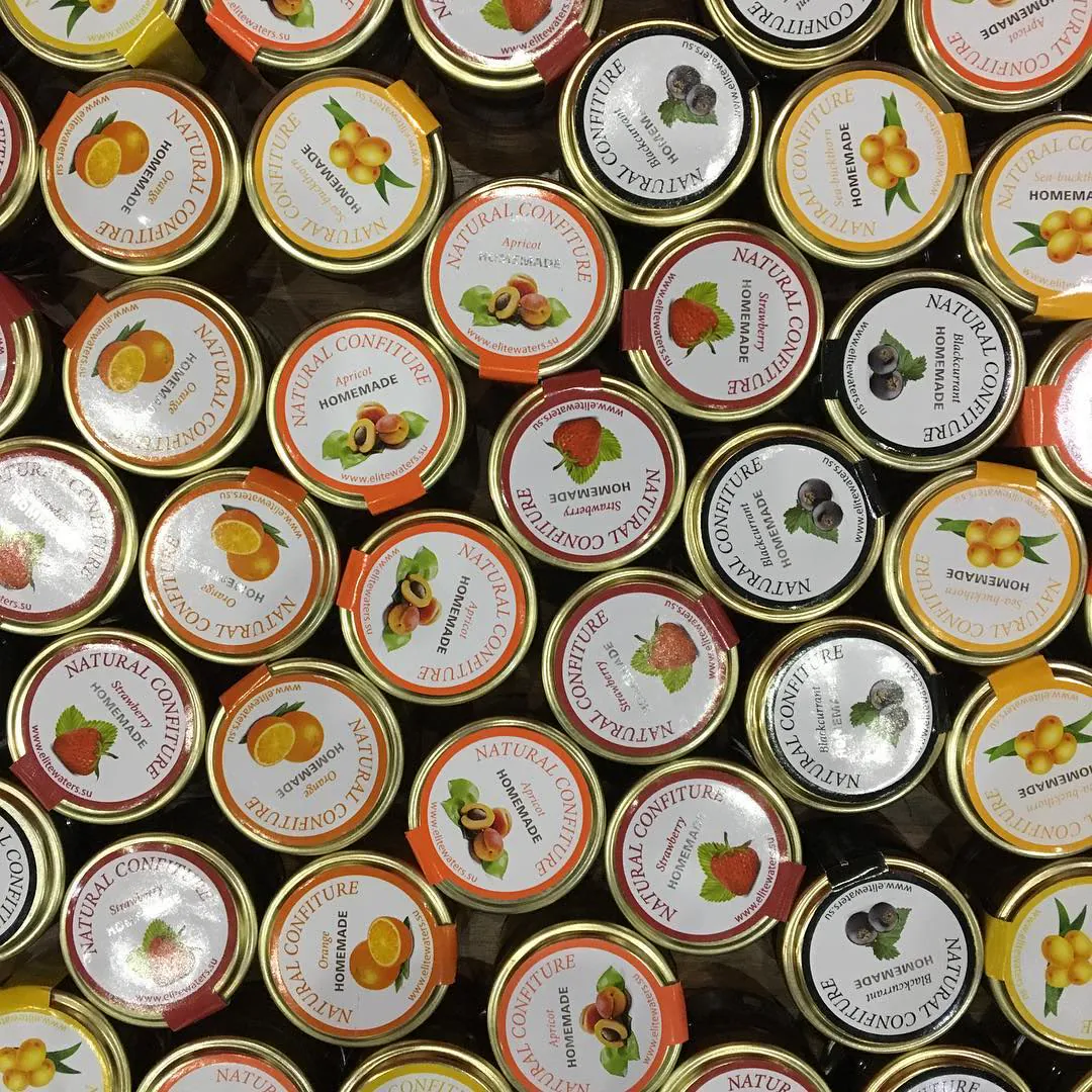 Rows of small jars of homemade jam, seen from above