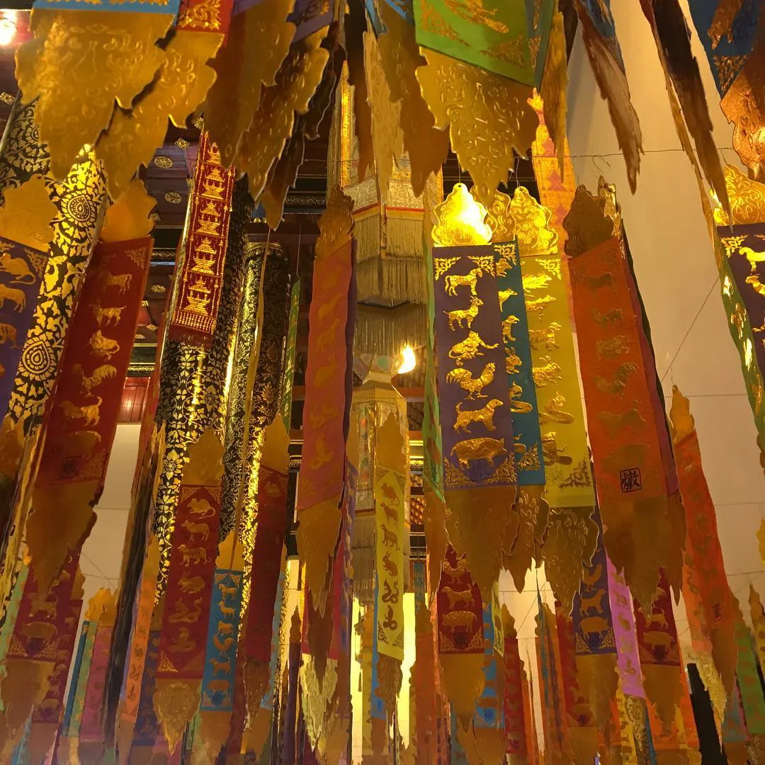 Gold and red paper banners hanging from a ceiling for the Lunar New Year