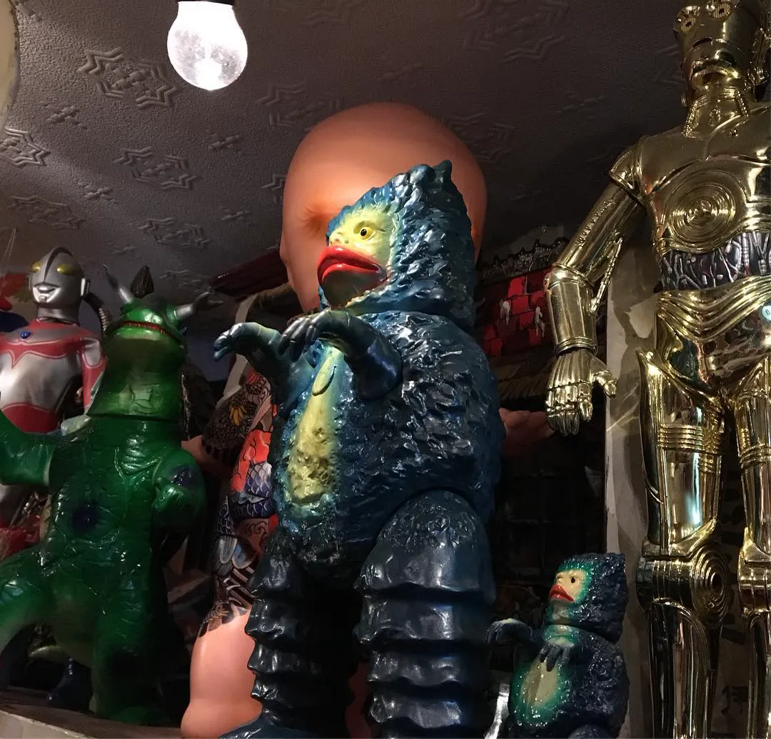 A shelf of old toys in Kyoto: rubber monster figures, an Ultraman and a gold C-3PO