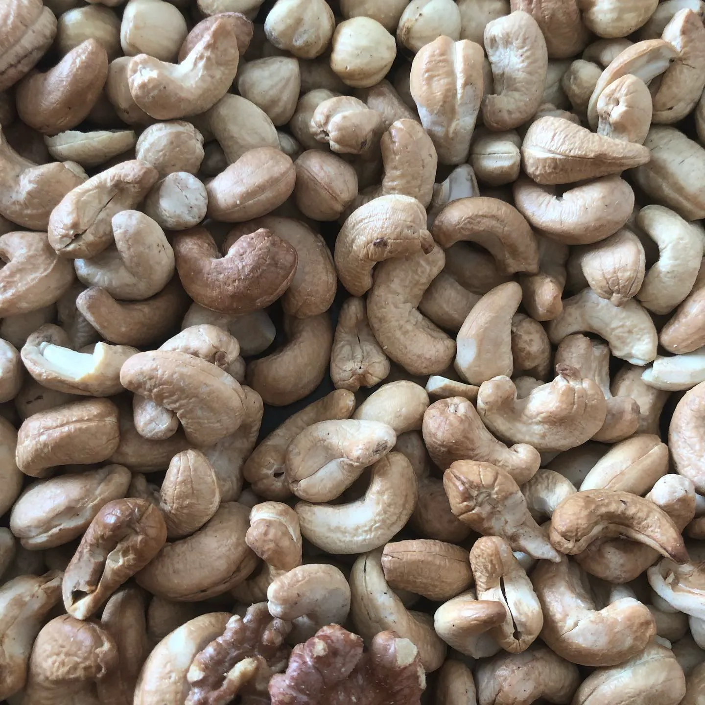 A pile of roasted cashews and walnuts